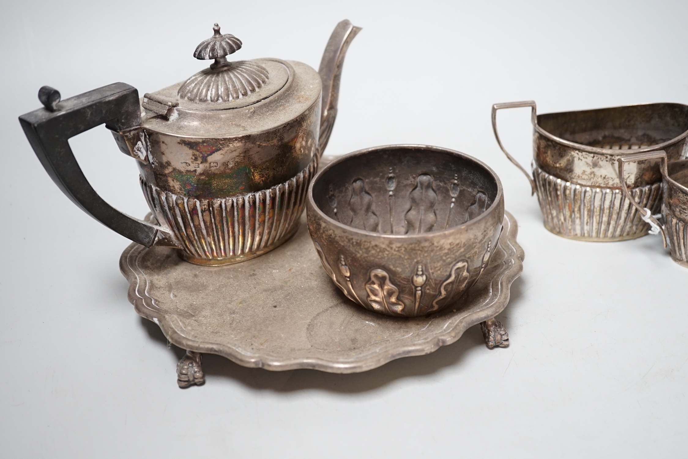 A late Victorian silver sugar bowl, William & John Barnard, London, 1891, a silver three piece bachelor’s tea set and a silver waiter, 27.9oz.
